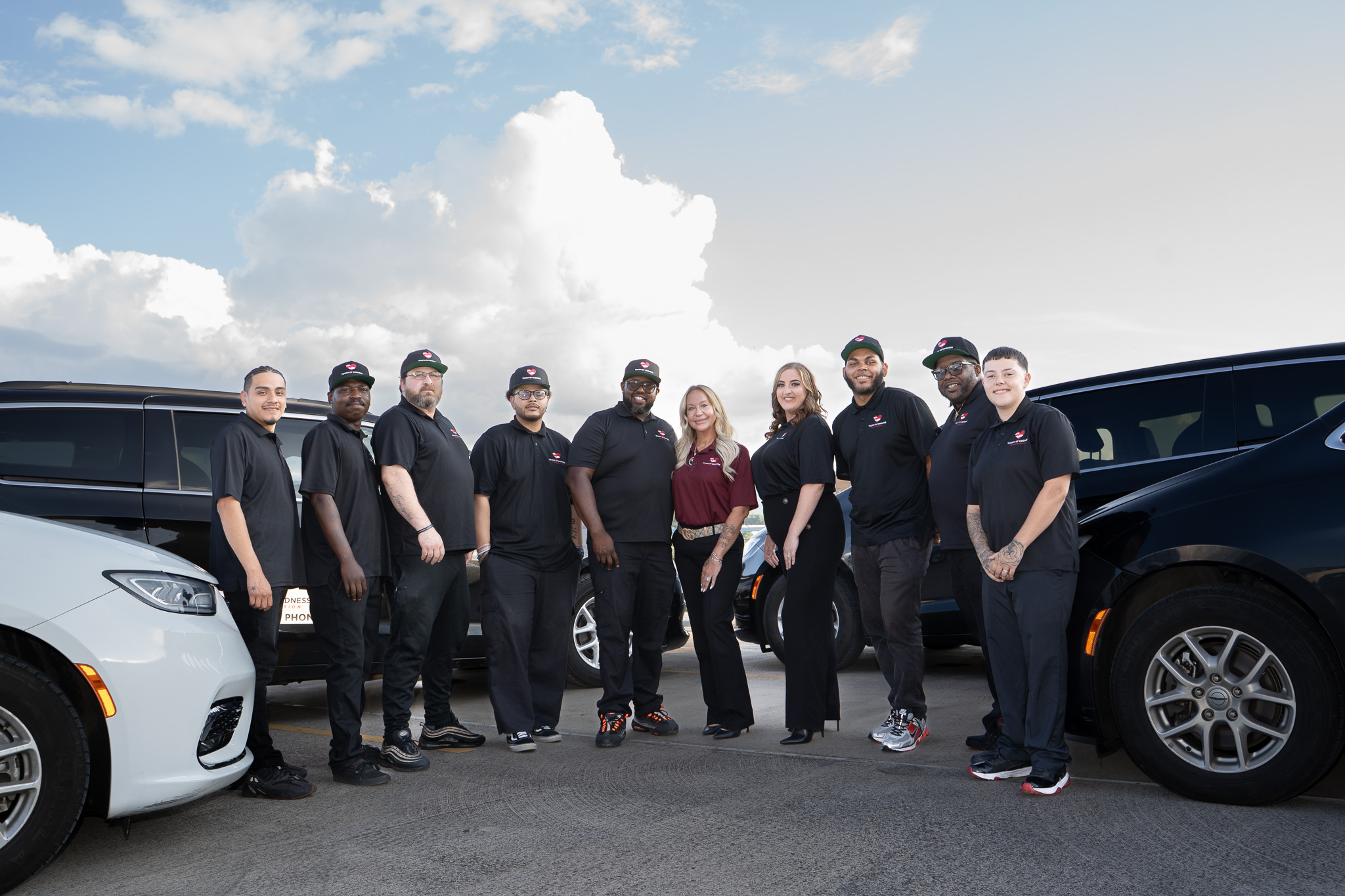 Touch of Kindness team beside medical transportation vehicles